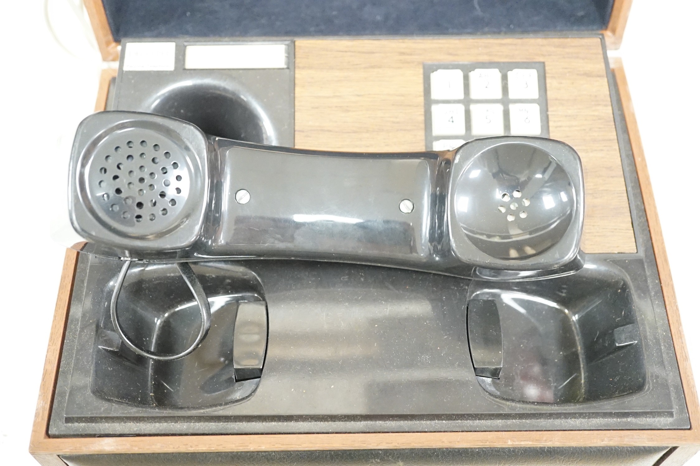 A Deco-Tel personal telephone set in hinged case